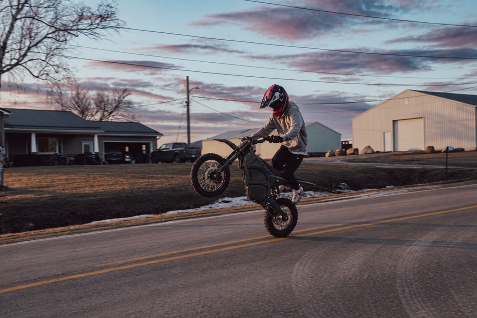 Electric off-road rider on a dirt trail at dusk